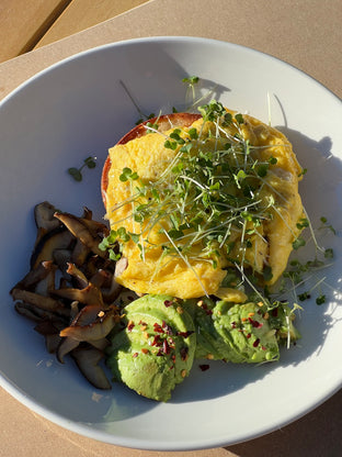 Homegrown arugula microgreens on eggs, bagel, avocado easy breakfast
