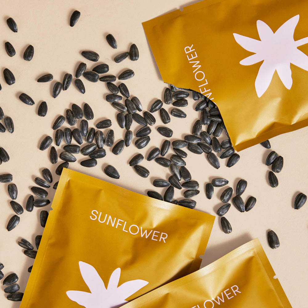 Leath Sunflower seed pack torn open with seeds spread out - organic & non-GMO